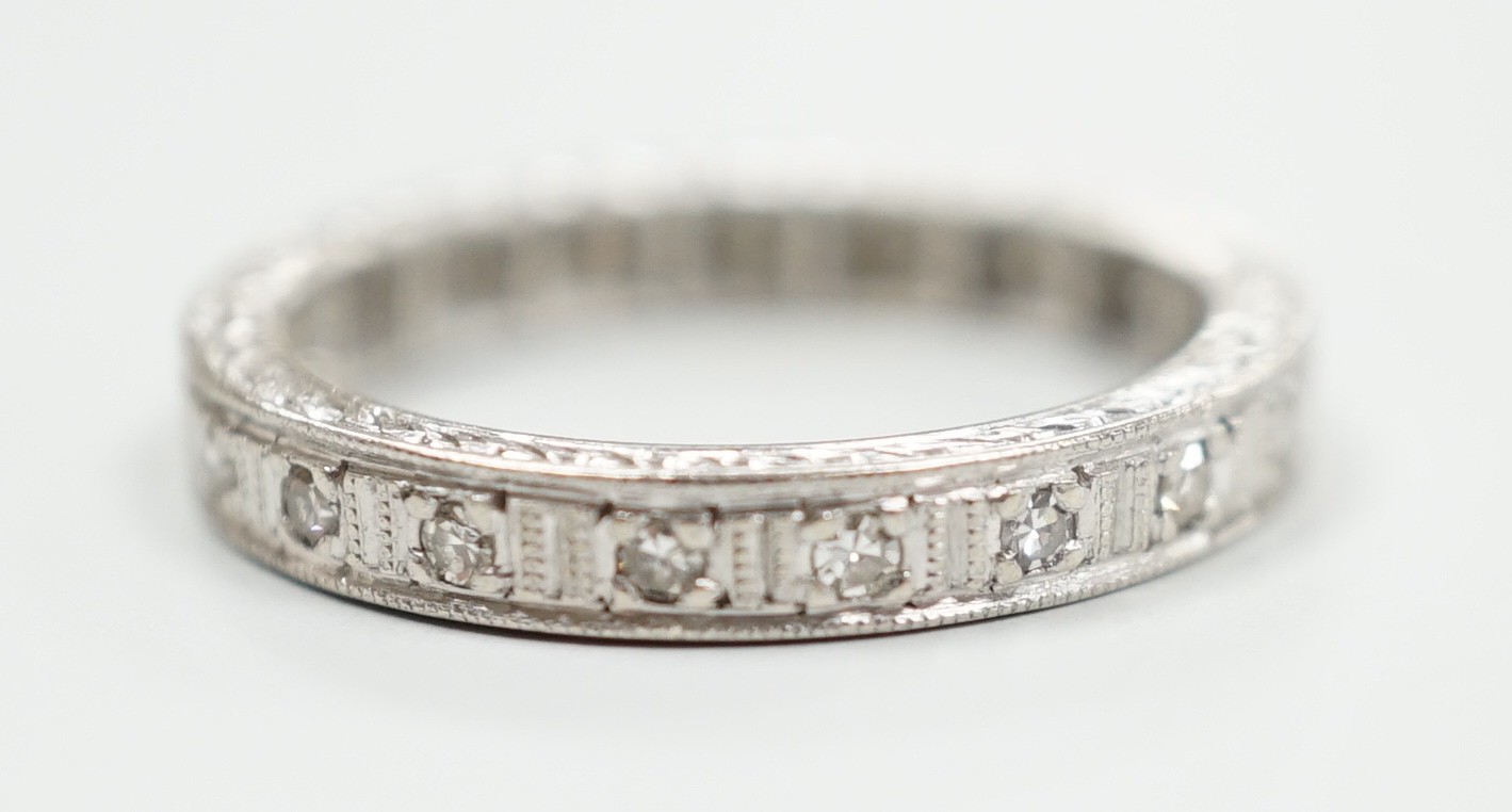 A white metal, stamped plat and diamond chip set full eternity ring, size K, gross weight 3.7 grams.